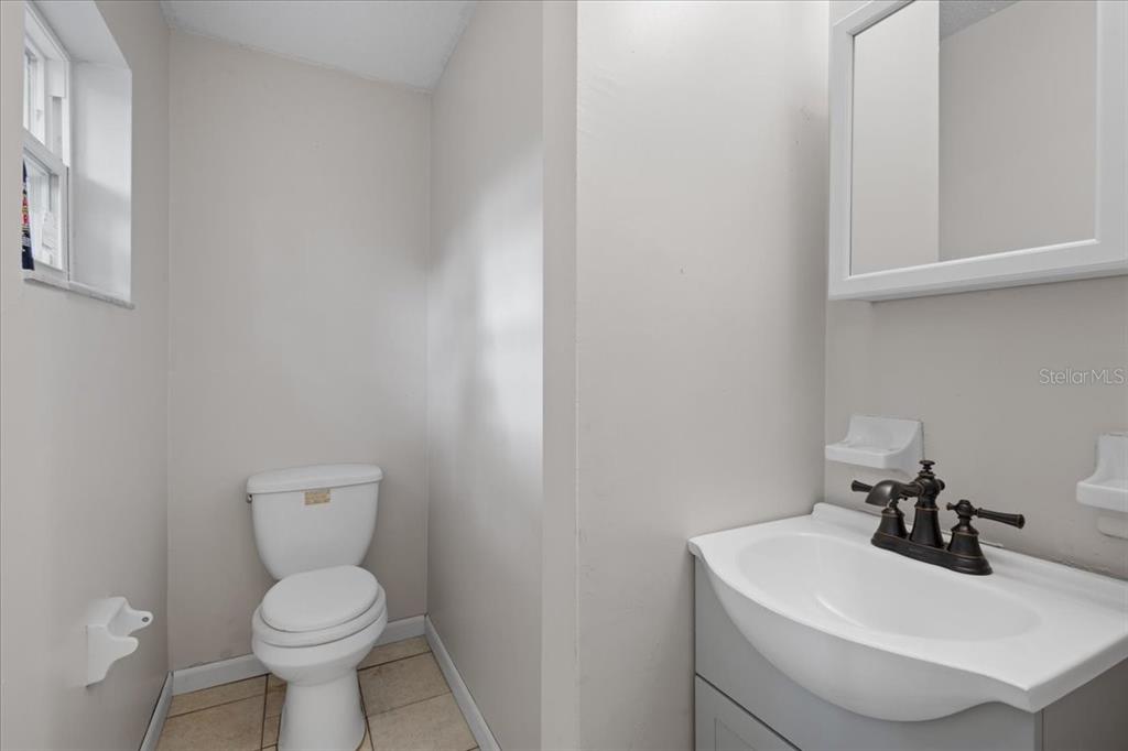 1315 Southwest 252nd Street Newberry, FL 32669 - Photo 22 of 29 a bathroom with a toilet sink and mirror