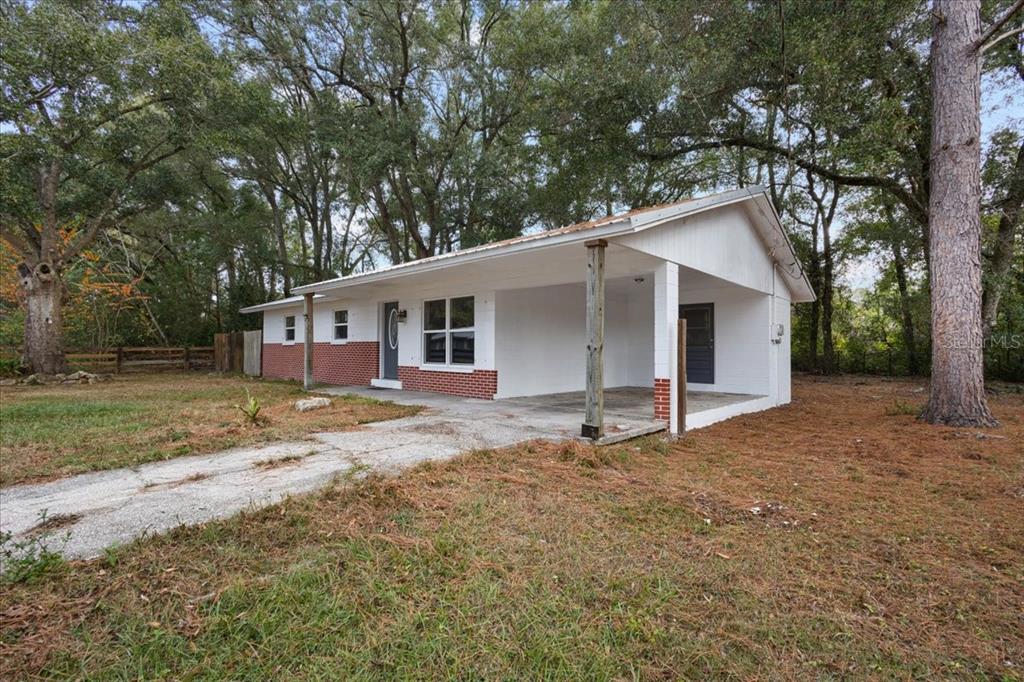 1315 Southwest 252nd Street Newberry, FL 32669 - Photo 3 of 29 a view of a house with a yard and large tree