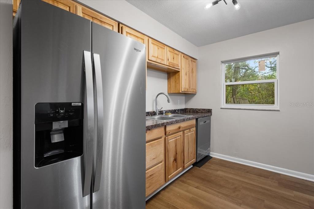 1315 Southwest 252nd Street Newberry, FL 32669 - Photo 10 of 29 a kitchen with stainless steel appliances granite countertop a refrigerator and a sink