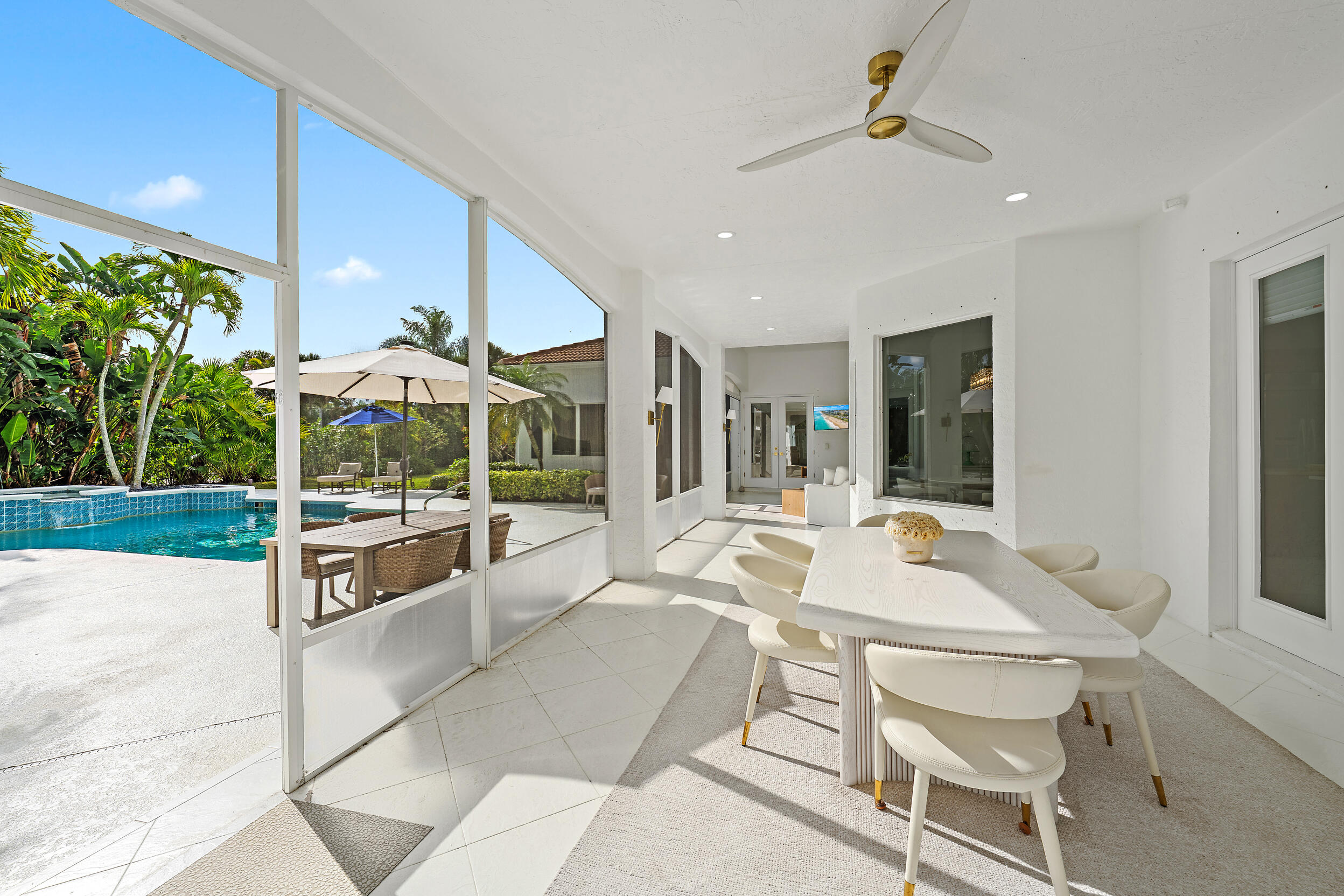 325 Eagle Drive Jupiter, FL 33477 - Photo 12 of 48 a view of a patio with a table and chairs