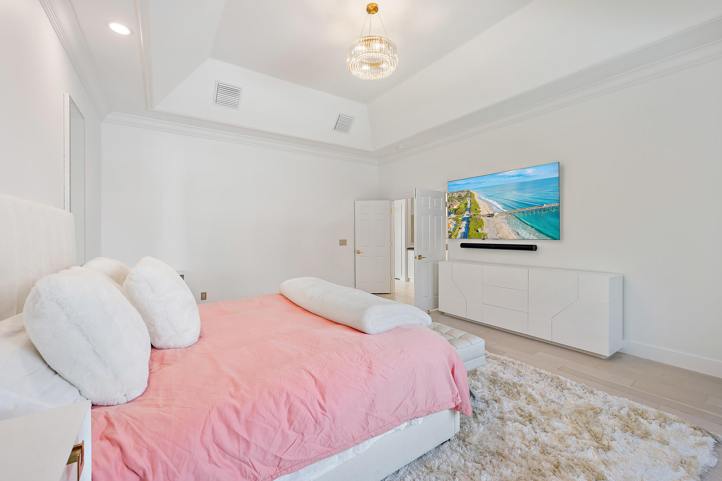 325 Eagle Drive Jupiter, FL 33477 - Photo 15 of 48 a bedroom with a bed and a painting on the wall