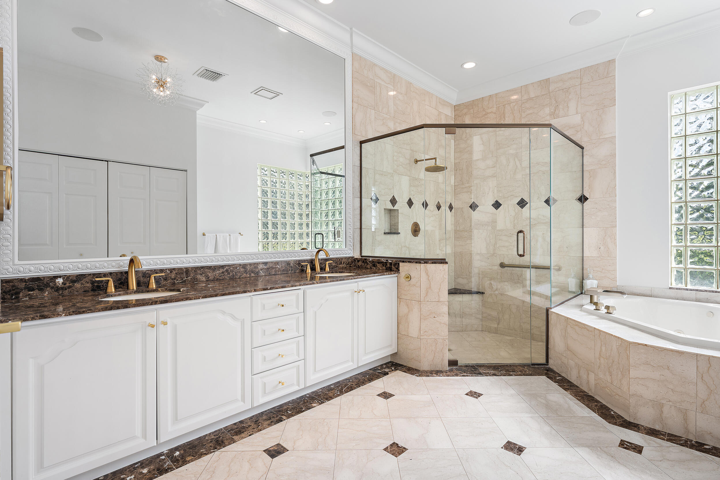 325 Eagle Drive Jupiter, FL 33477 - Photo 20 of 48 a large bathroom with a tub a sink and mirror