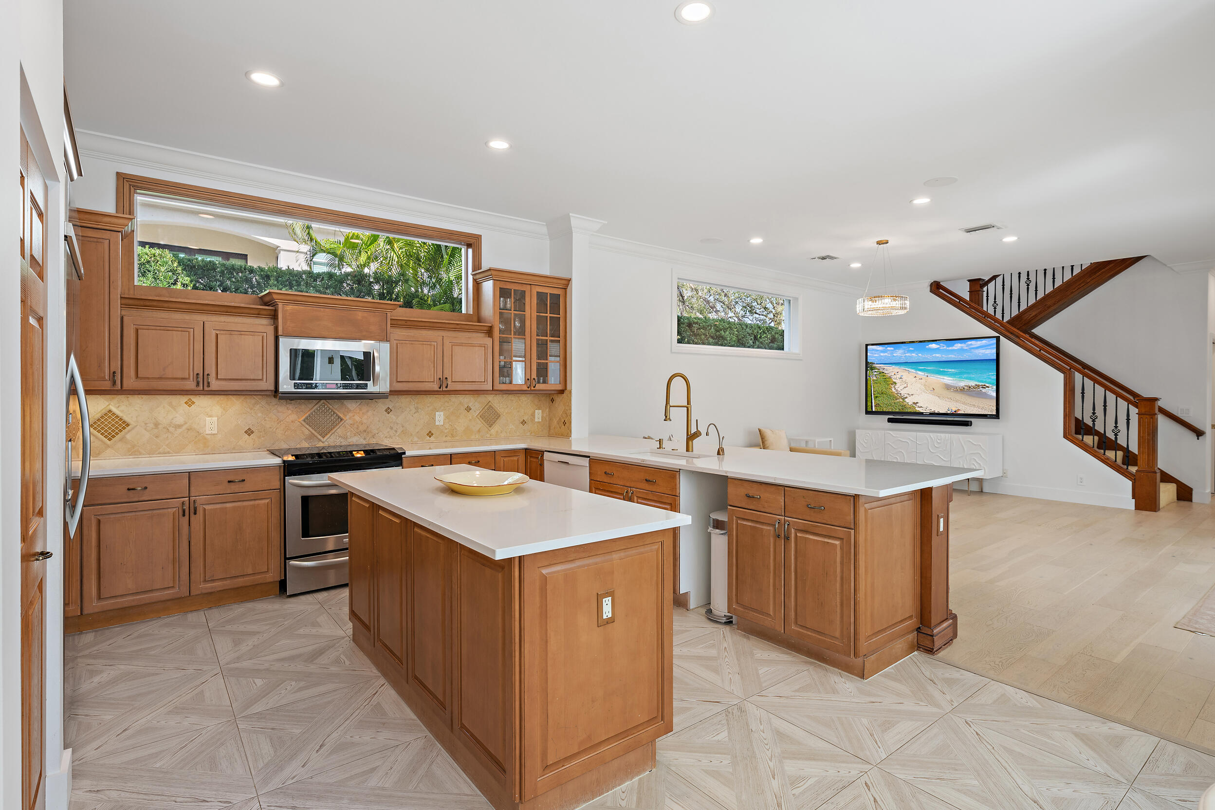 325 Eagle Drive Jupiter, FL 33477 - Photo 22 of 48 a kitchen with stainless steel appliances granite countertop a stove and a sink