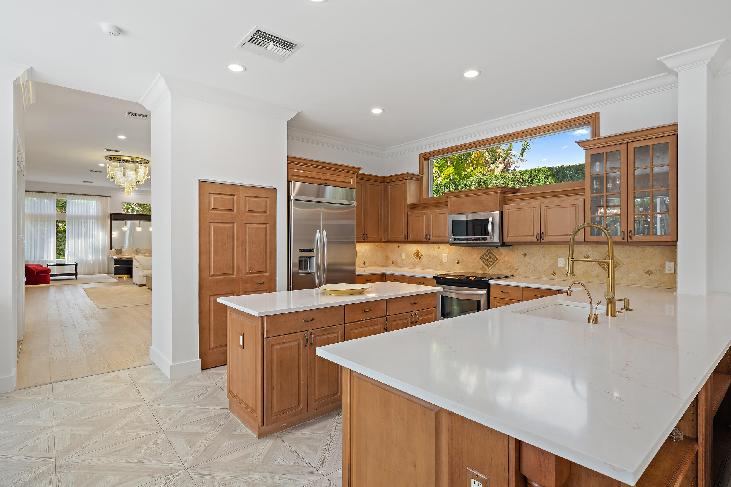325 Eagle Drive Jupiter, FL 33477 - Photo 23 of 48 a kitchen with stainless steel appliances a stove a refrigerator a sink and a refrigerator