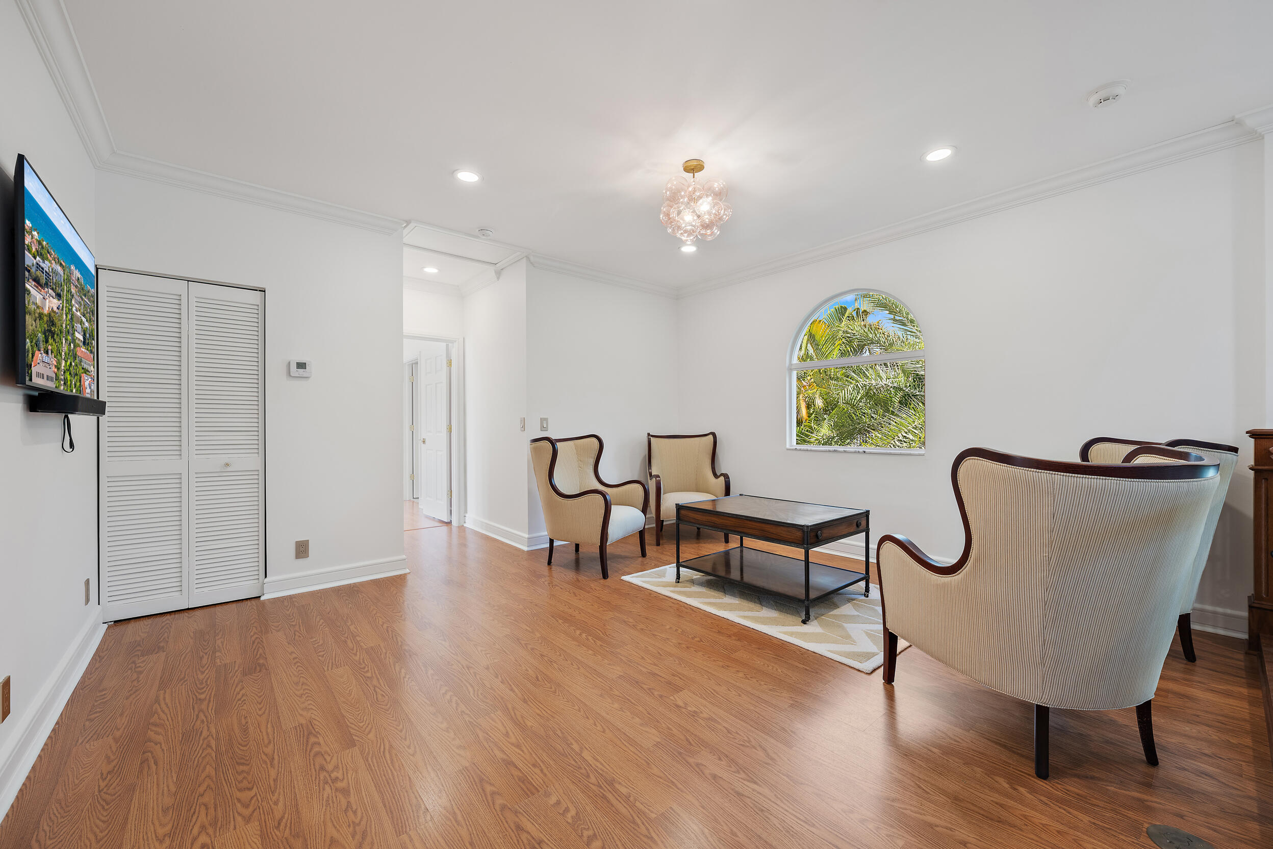 325 Eagle Drive Jupiter, FL 33477 - Photo 24 of 48 a view of an empty room with window and wooden floor