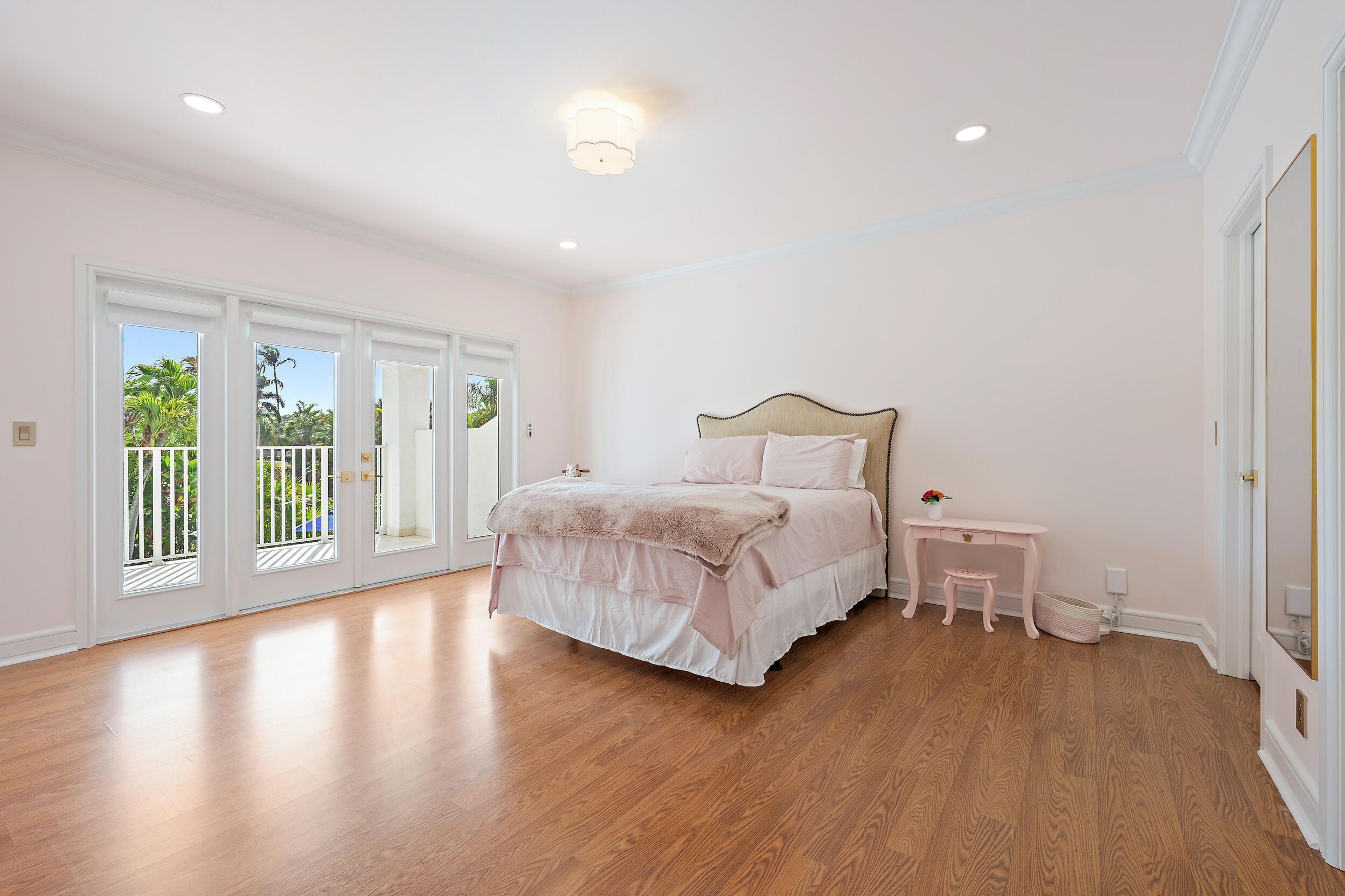 325 Eagle Drive Jupiter, FL 33477 - Photo 26 of 48 a bedroom with a bed and wooden floor