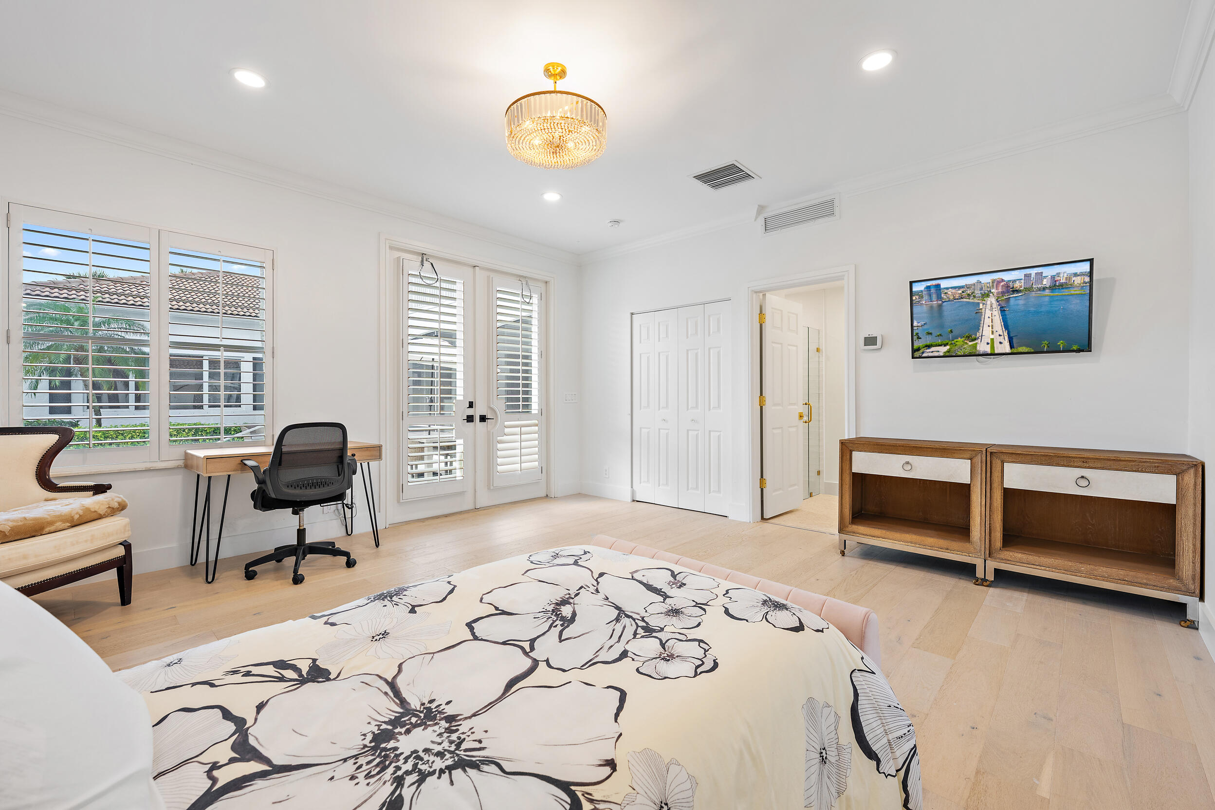325 Eagle Drive Jupiter, FL 33477 - Photo 30 of 48 a bedroom with a bed and wooden floor