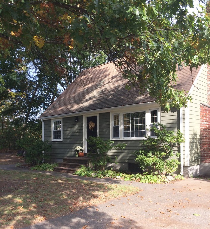 23 Magnolia Road Natick, MA 01760 - Photo 2 of 13 a front view of a house with garden