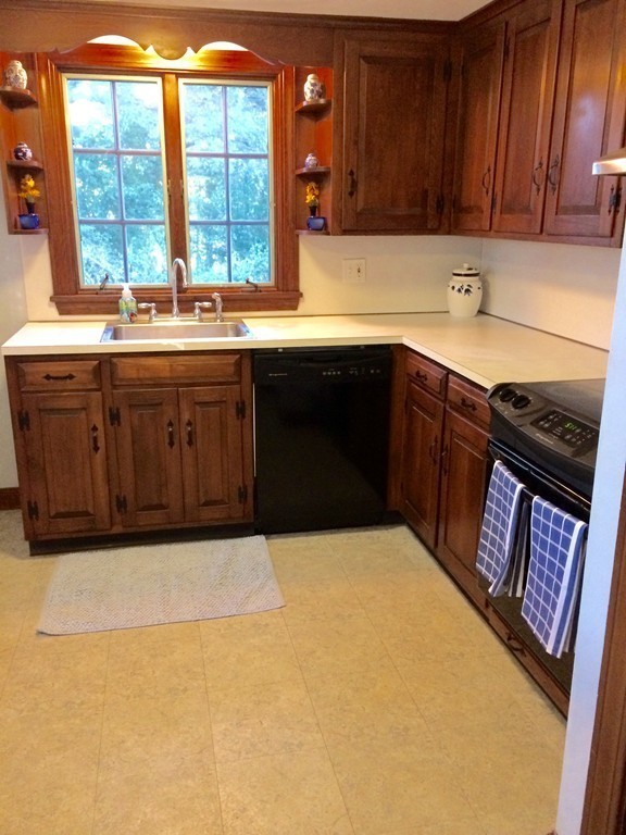 23 Magnolia Road Natick, MA 01760 - Photo 6 of 13 a kitchen with a sink a window and cabinets