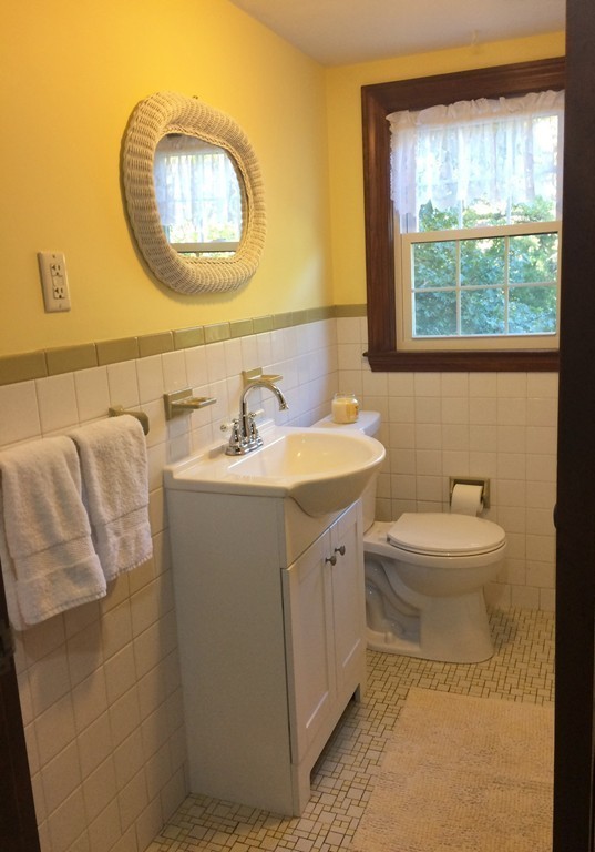 23 Magnolia Road Natick, MA 01760 - Photo 10 of 13 a bathroom with a toilet sink vanity and mirror