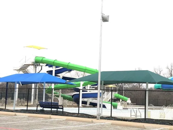 a view of a patio with a table and chairs under an umbrella