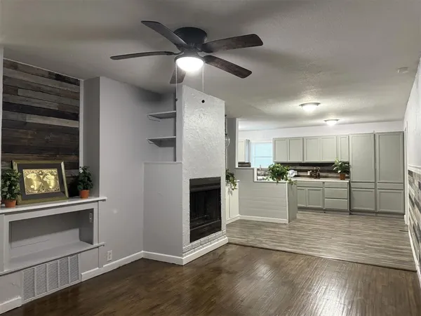a view of kitchen with cabinets and wooden floor