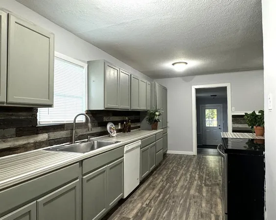 a kitchen with a sink and cabinets