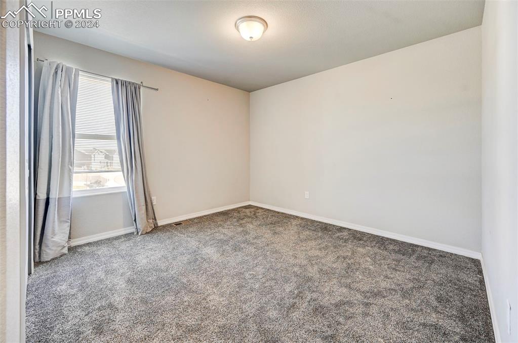 4472 Gneiss Loop Colorado Springs, CO 80938 - Photo 22 of 30 an empty room with windows