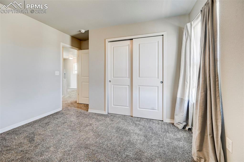 4472 Gneiss Loop Colorado Springs, CO 80938 - Photo 23 of 30 an empty room with closet and a window