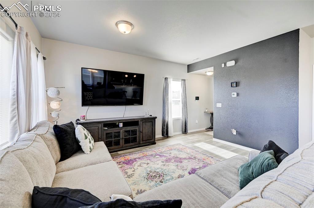 4472 Gneiss Loop Colorado Springs, CO 80938 - Photo 7 of 30 a bedroom with a bed and a flat screen tv