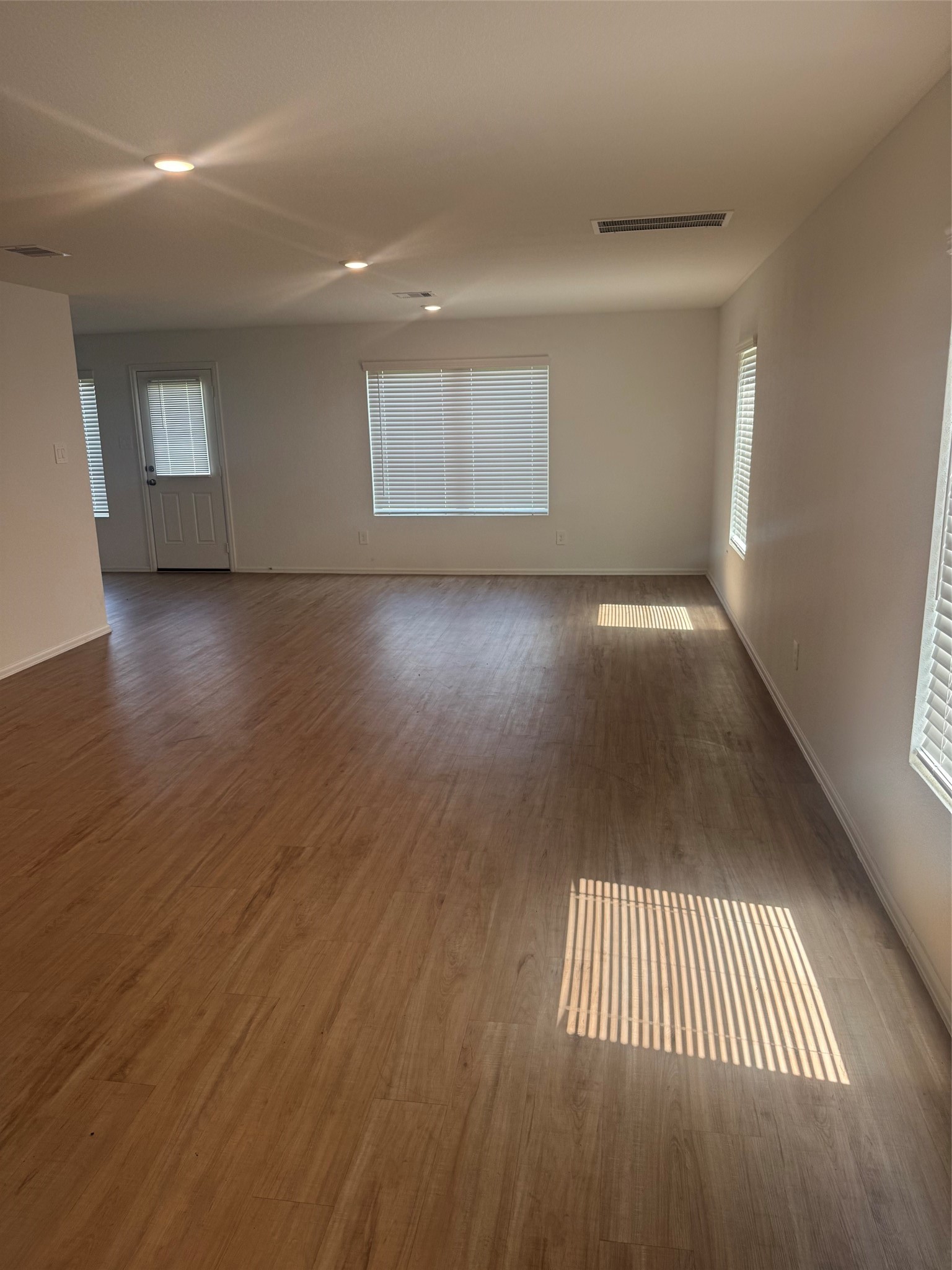 3202 Holly Stokes Way Conroe, TX 77301 - Photo 4 of 24 an empty room with wooden floor and windows