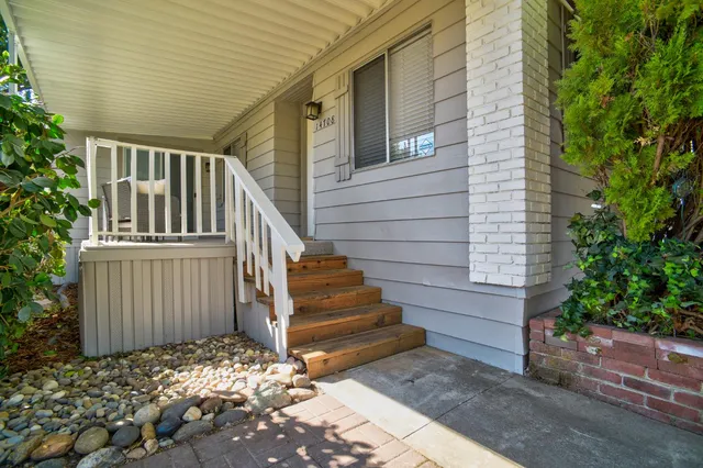 a view of wooden house with a yard