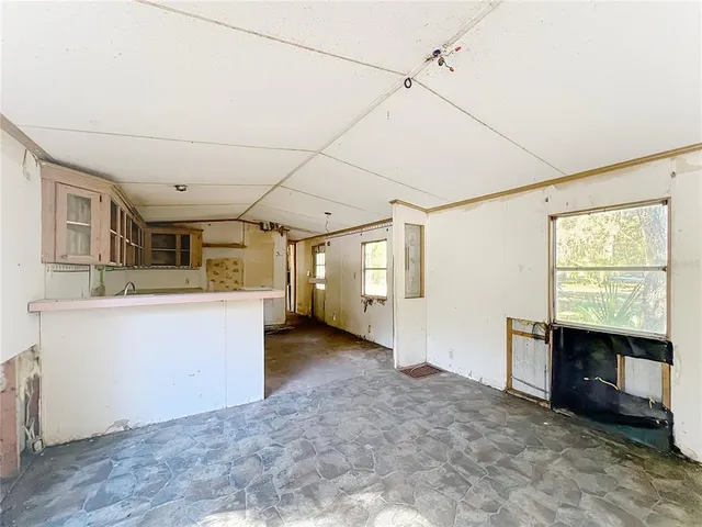 a kitchen with sink refrigerator and cabinets