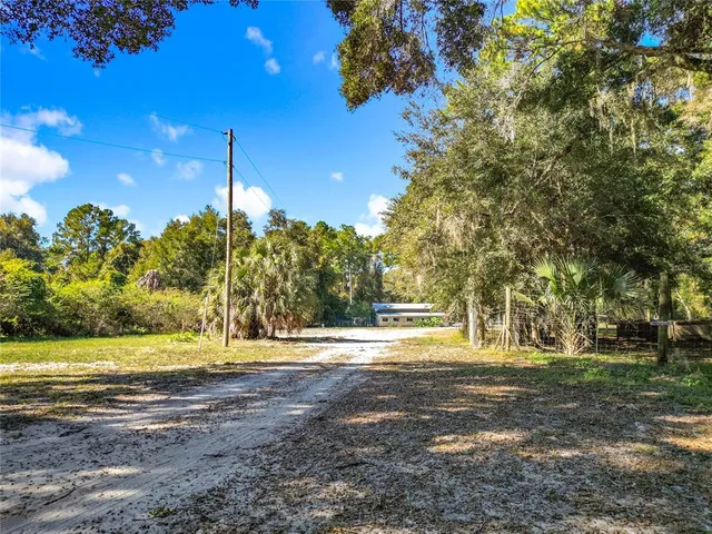 a backyard of a house with barbeque oven table and chairs