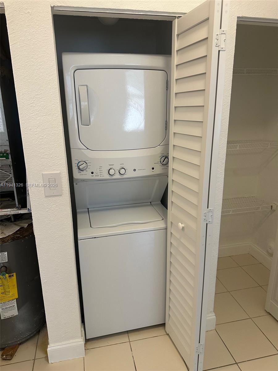 1663 Southeast 27th Drive, Unit 102 Homestead, FL 33035 - Photo 11 of 18 a utility room with dryer and washer