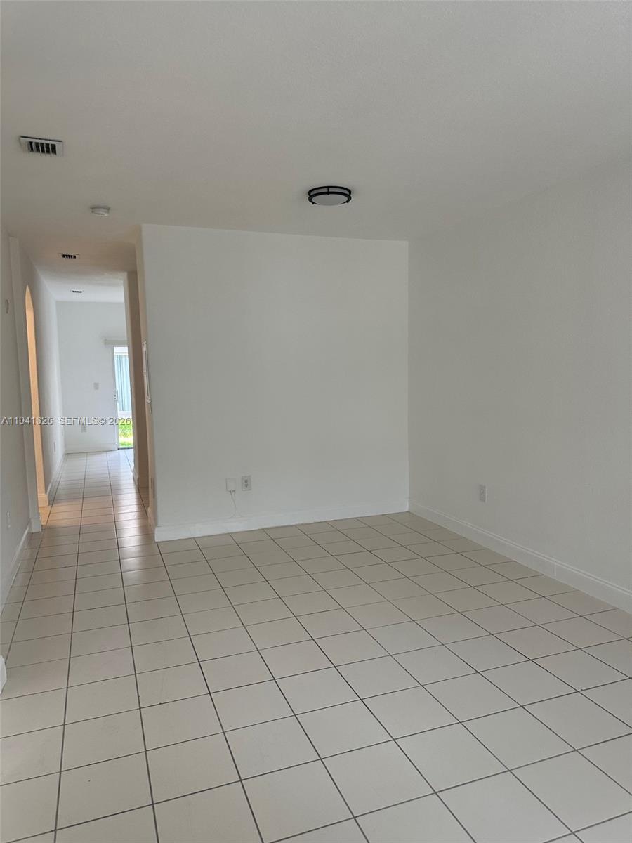 1663 Southeast 27th Drive, Unit 102 Homestead, FL 33035 - Photo 4 of 18 a view of an empty room