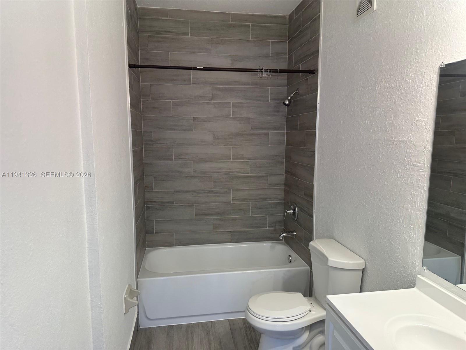 1663 Southeast 27th Drive, Unit 102 Homestead, FL 33035 - Photo 6 of 18 a bathroom with a toilet and a bathtub