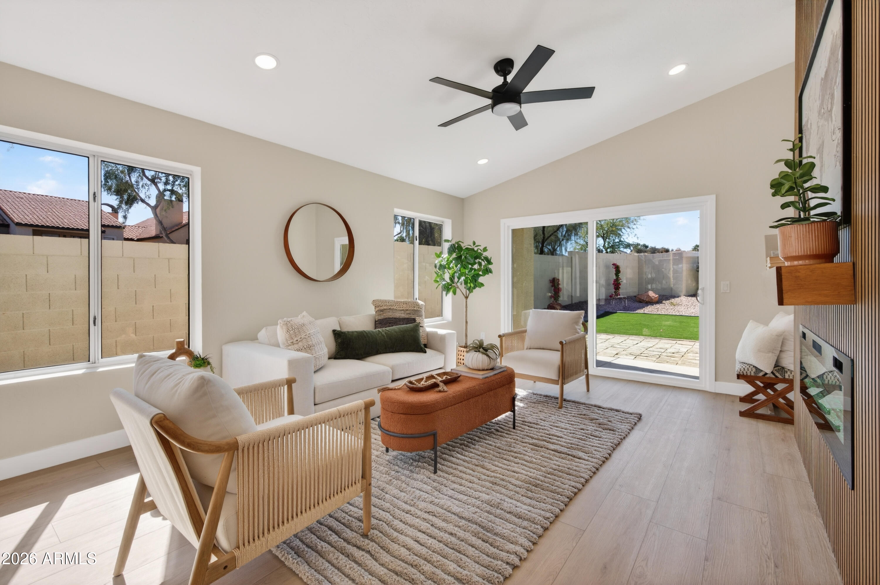 4814 East Monte Way Phoenix, AZ 85044 - Photo 12 of 42 a living room with furniture a fireplace and a floor to ceiling window