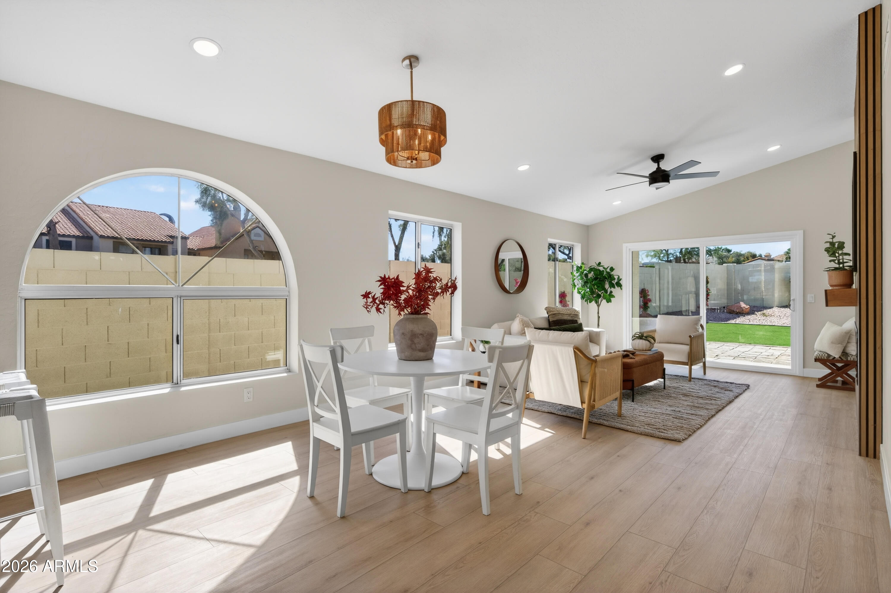 4814 East Monte Way Phoenix, AZ 85044 - Photo 13 of 42 a view of a dining room with furniture large windows and wooden floor