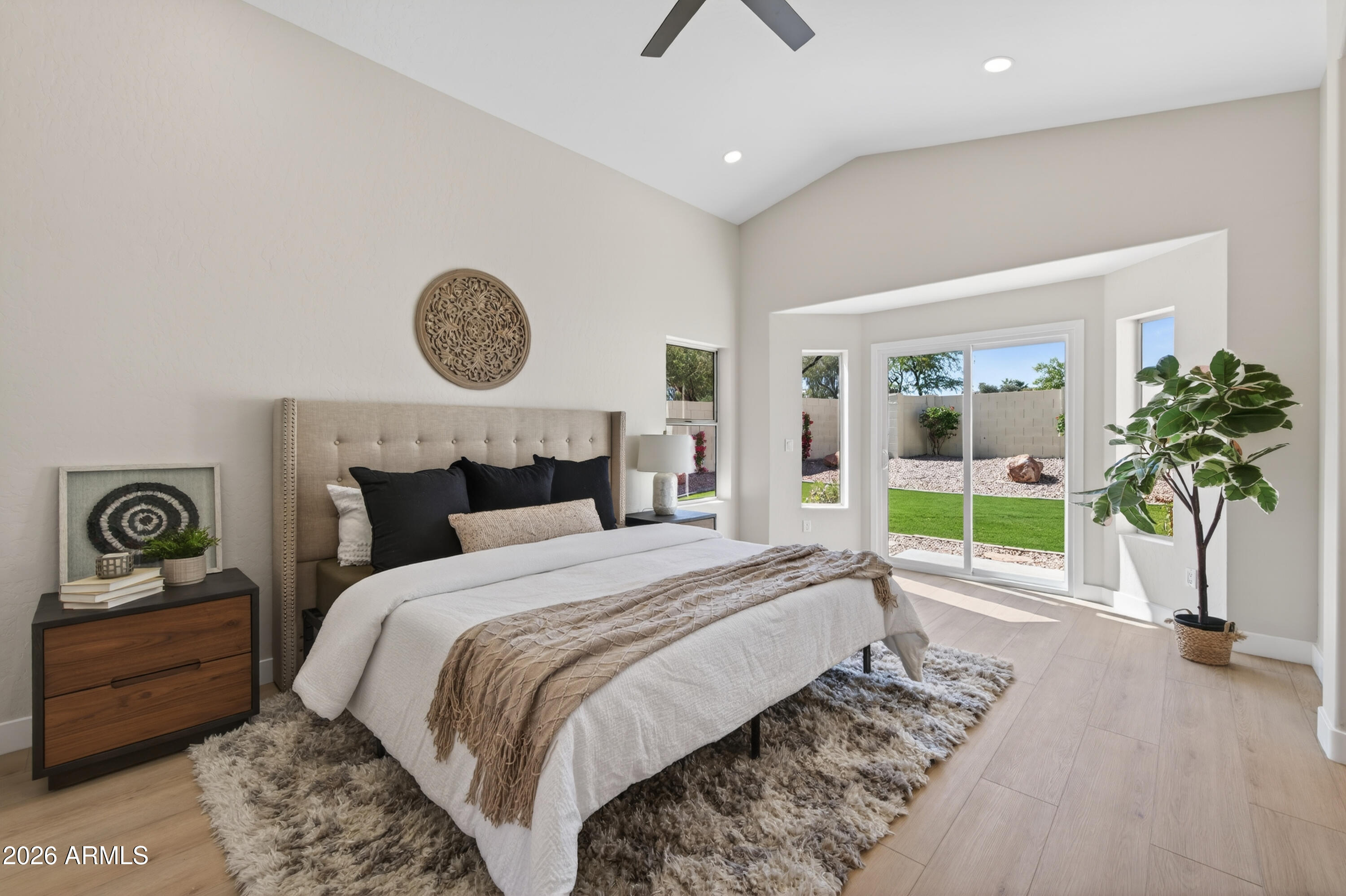 4814 East Monte Way Phoenix, AZ 85044 - Photo 15 of 42 a bedroom with a bed a couch and a potted plant