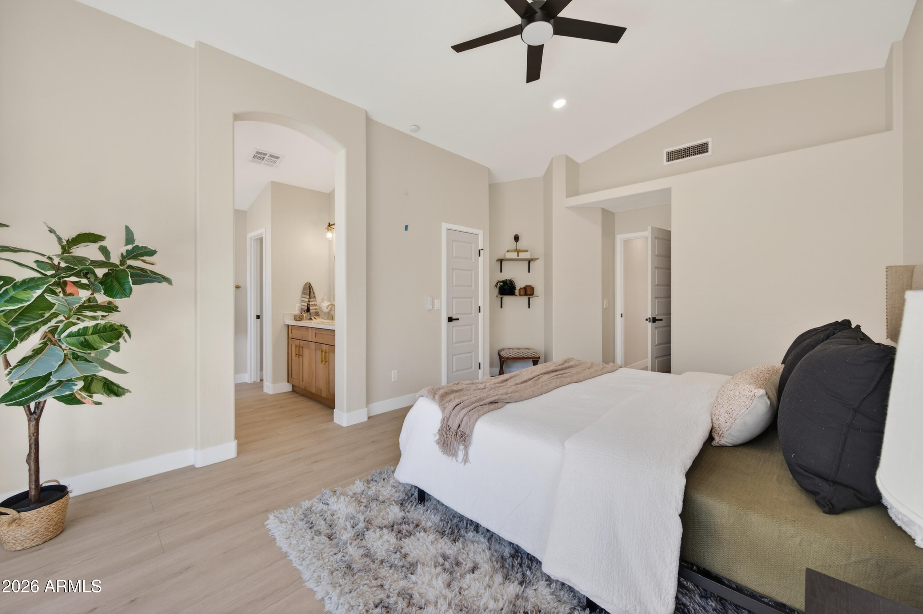 4814 East Monte Way Phoenix, AZ 85044 - Photo 16 of 42 a bedroom with a bed and a potted plant