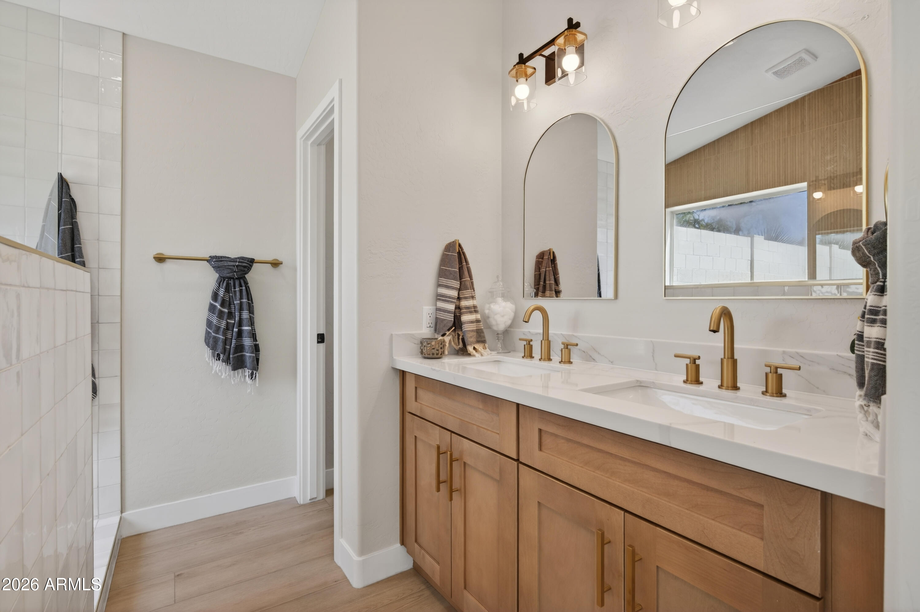4814 East Monte Way Phoenix, AZ 85044 - Photo 18 of 42 a bathroom with a double vanity sink and mirror