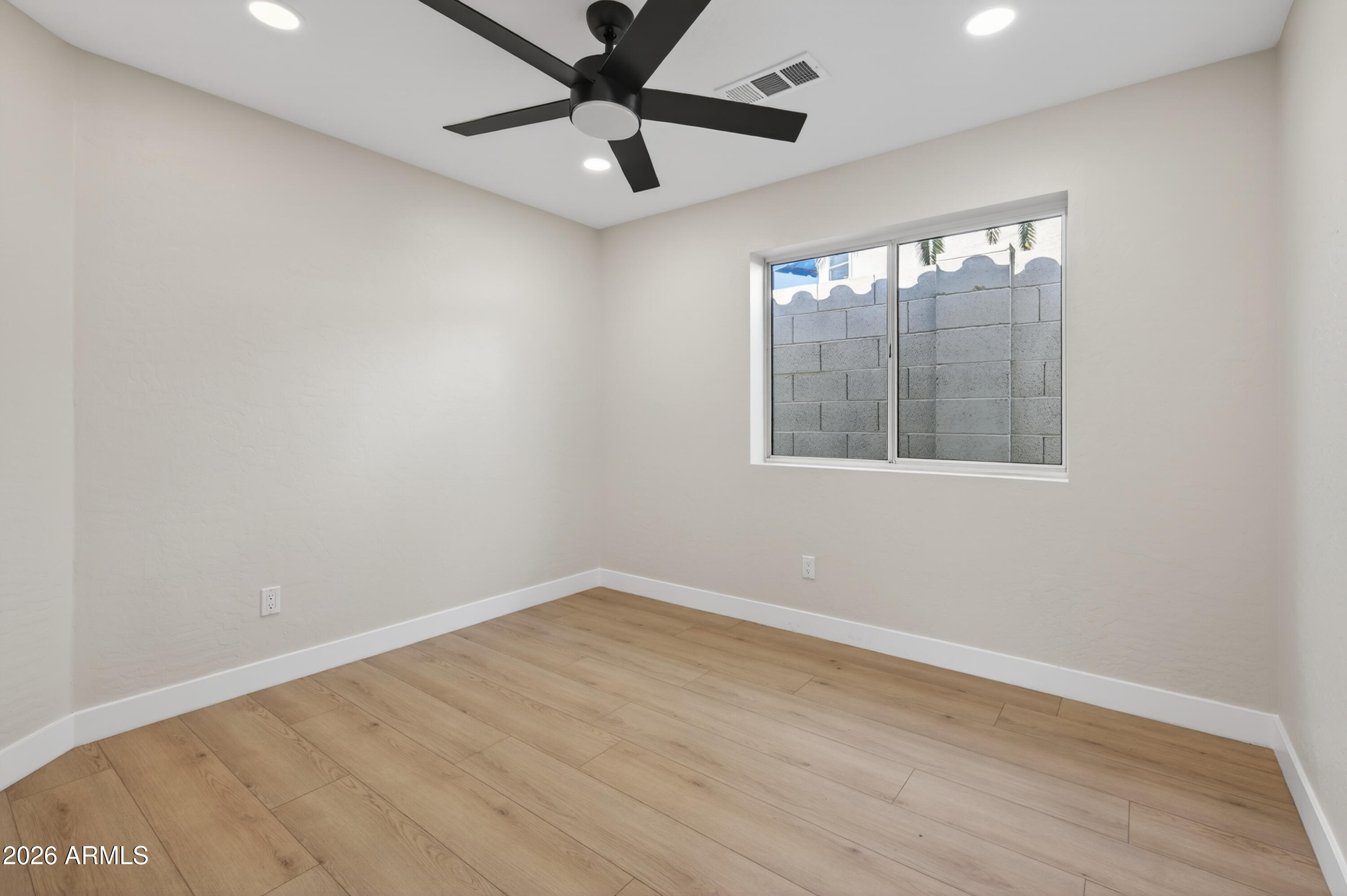 4814 East Monte Way Phoenix, AZ 85044 - Photo 20 of 42 an empty room with wooden floor and windows
