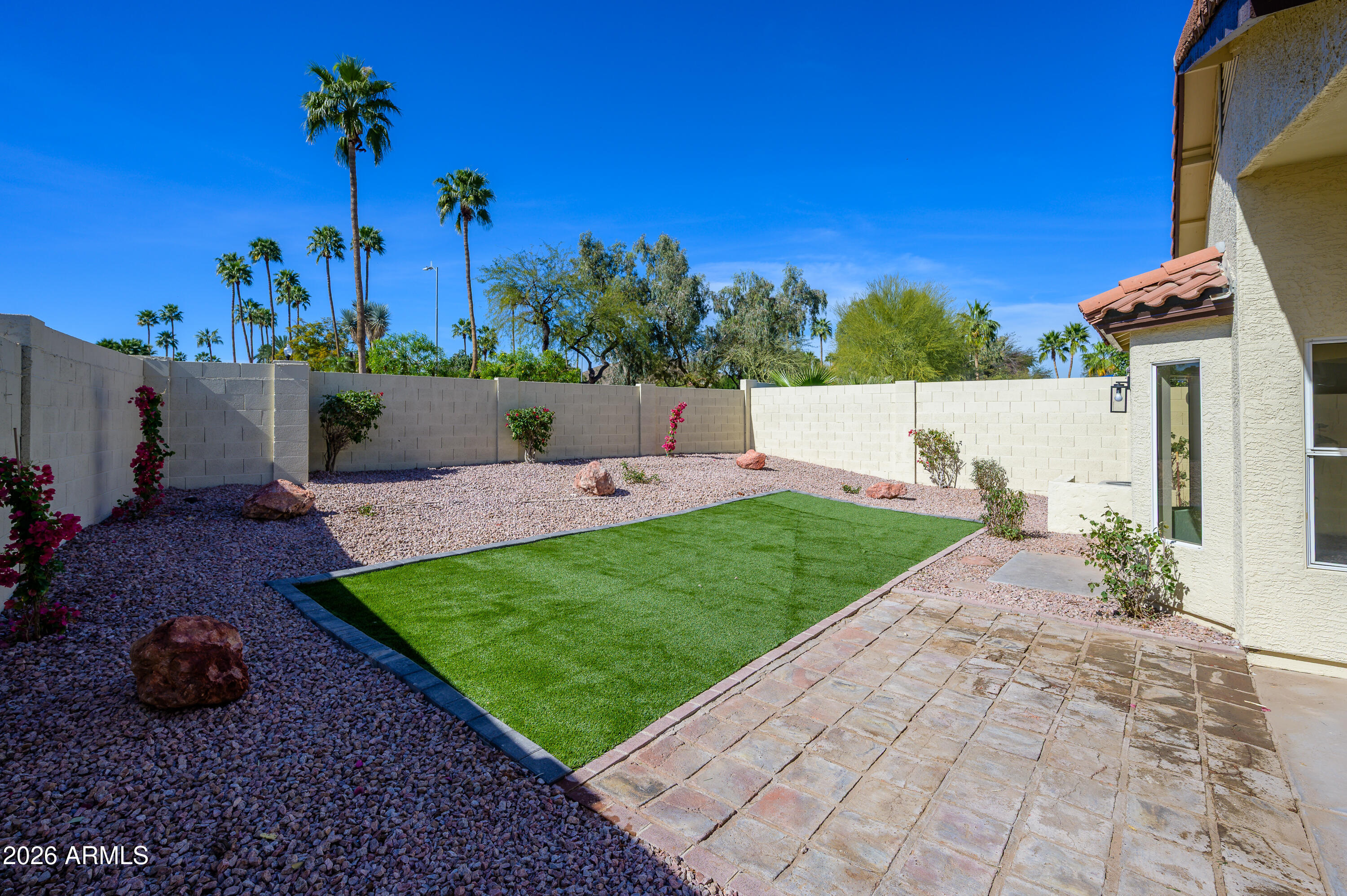 4814 East Monte Way Phoenix, AZ 85044 - Photo 25 of 42 a view of a garden with a bench in front of it