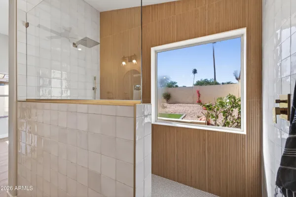 a view of a bathroom with a glass door shower and sink