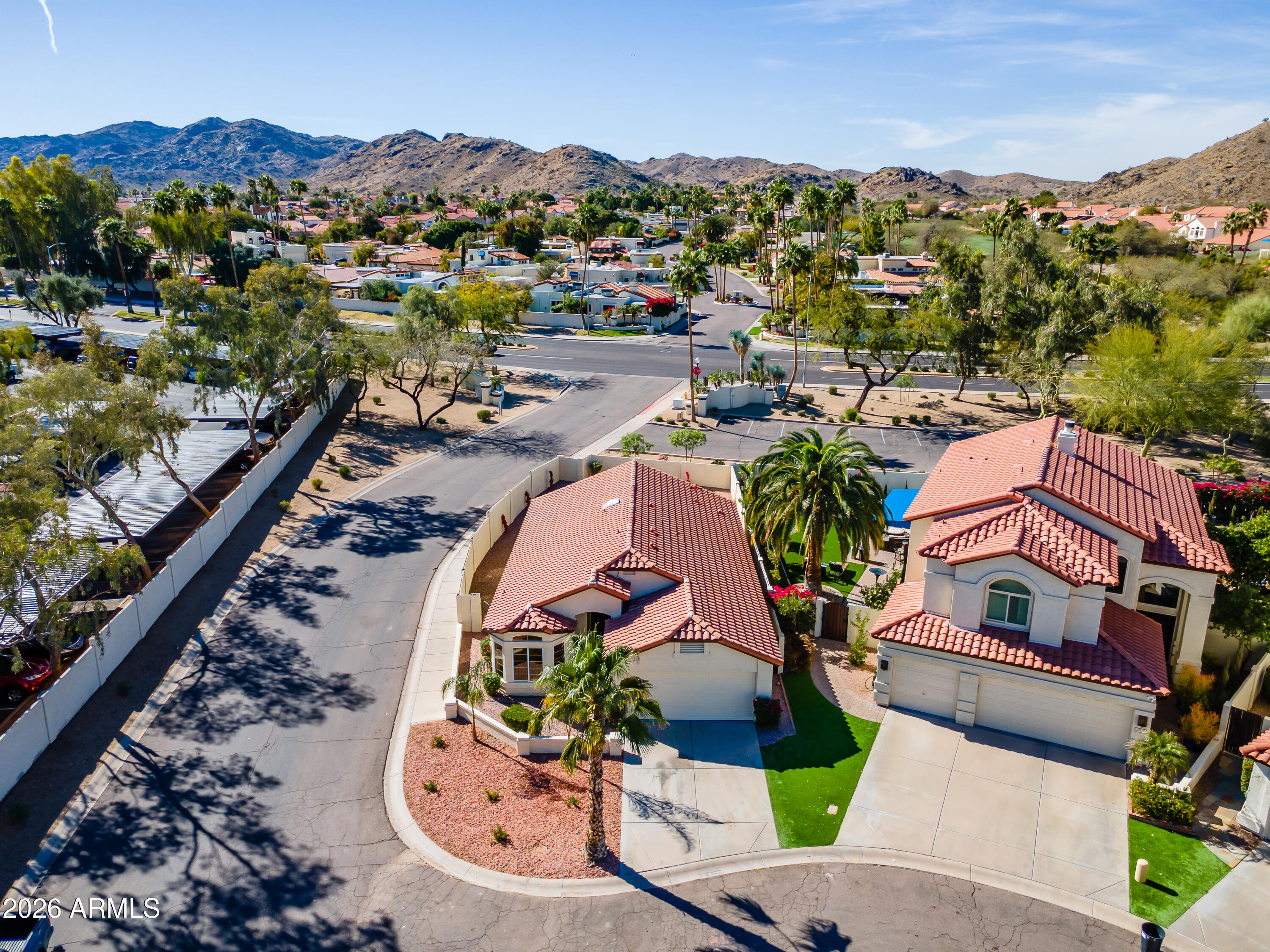 4814 East Monte Way Phoenix, AZ 85044 - Photo 33 of 42 an aerial view of a house with a swimming pool lake view and mountain view