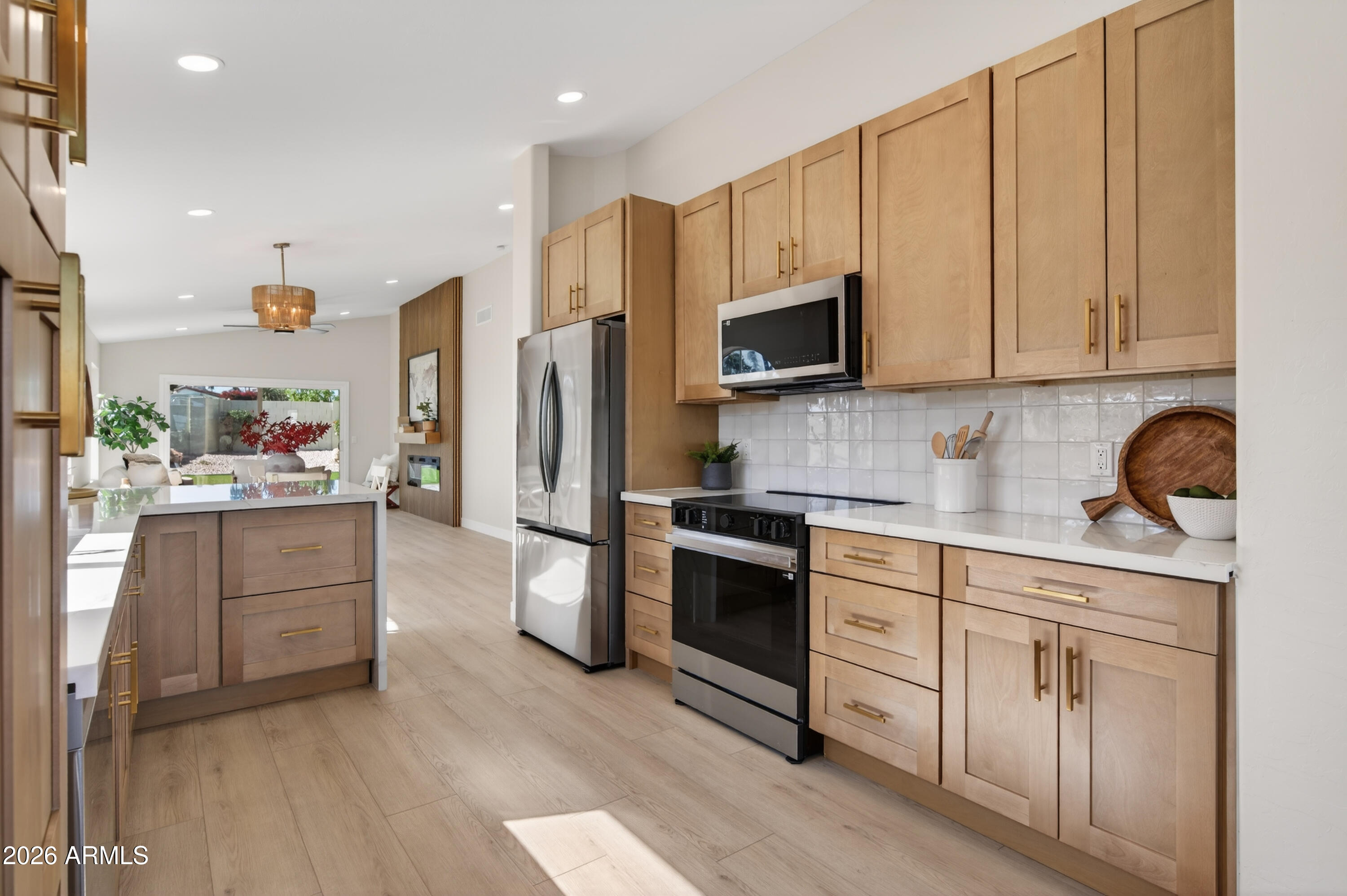 4814 East Monte Way Phoenix, AZ 85044 - Photo 7 of 42 a kitchen with white cabinets and stainless steel appliances