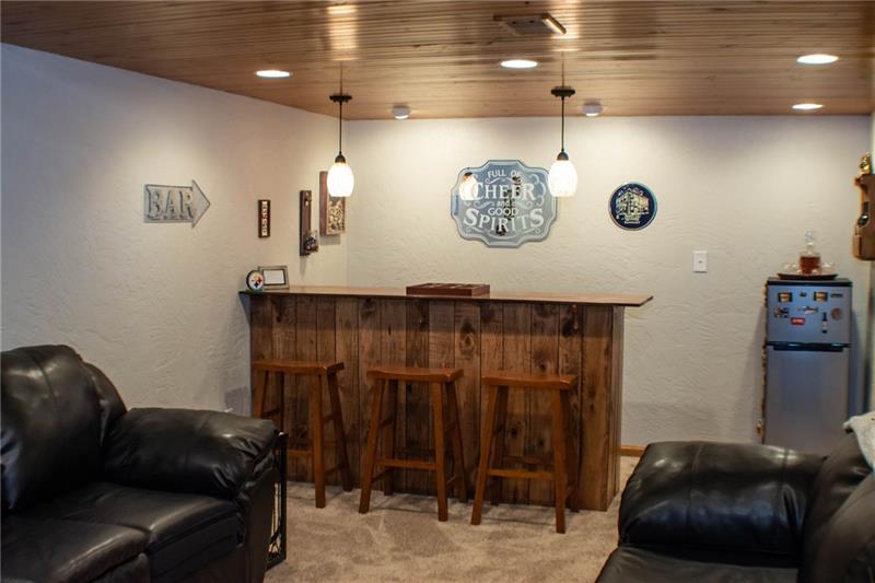 1545 McElree Road Washington, PA 15301 - Photo 14 of 24 Lower level family room with custom bar, tongue & groove ceiling with recessed lighting.