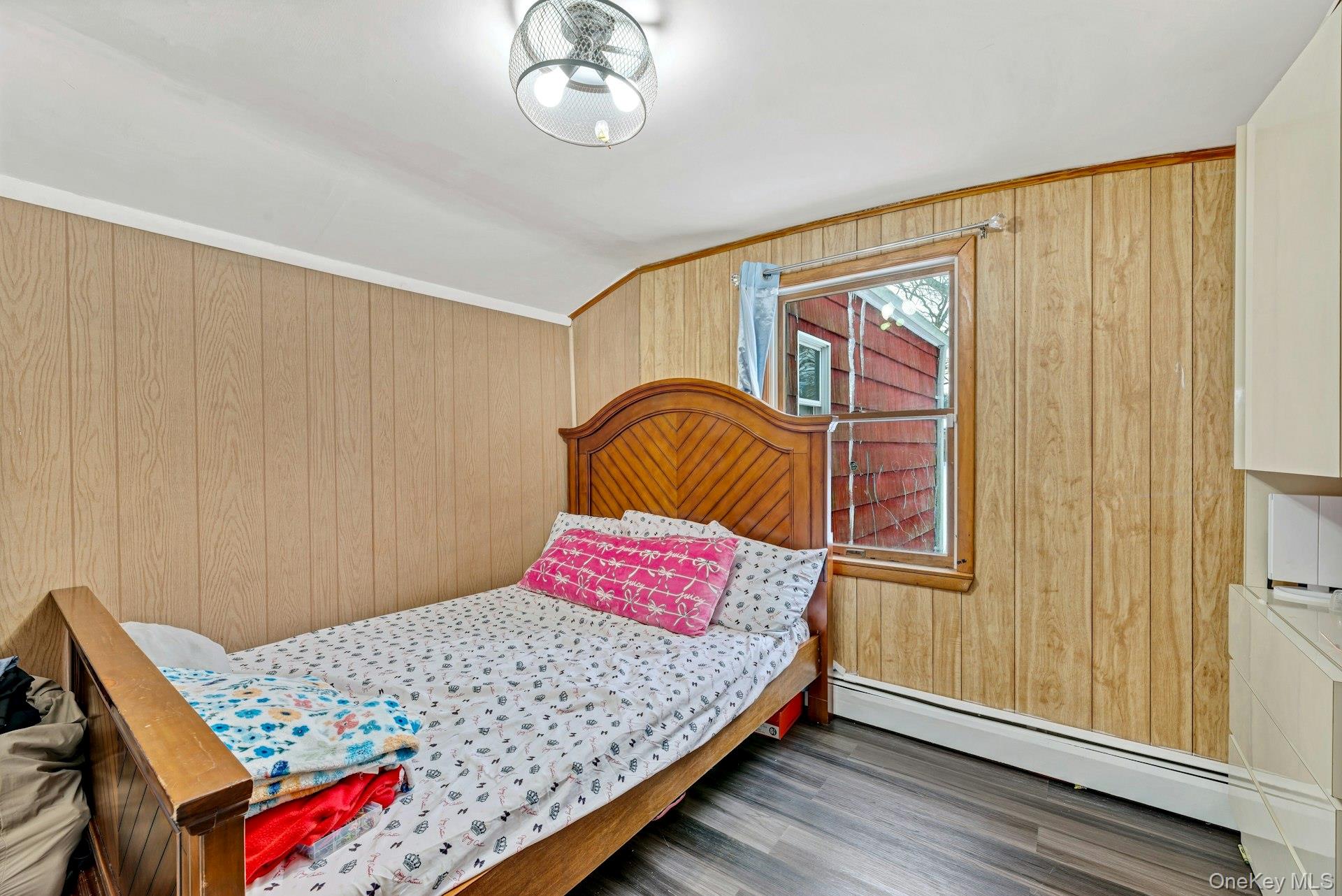 32 Stackyard Drive Mastic Beach, NY 11951 - Photo 18 of 25 a bedroom with a bed and wooden floor
