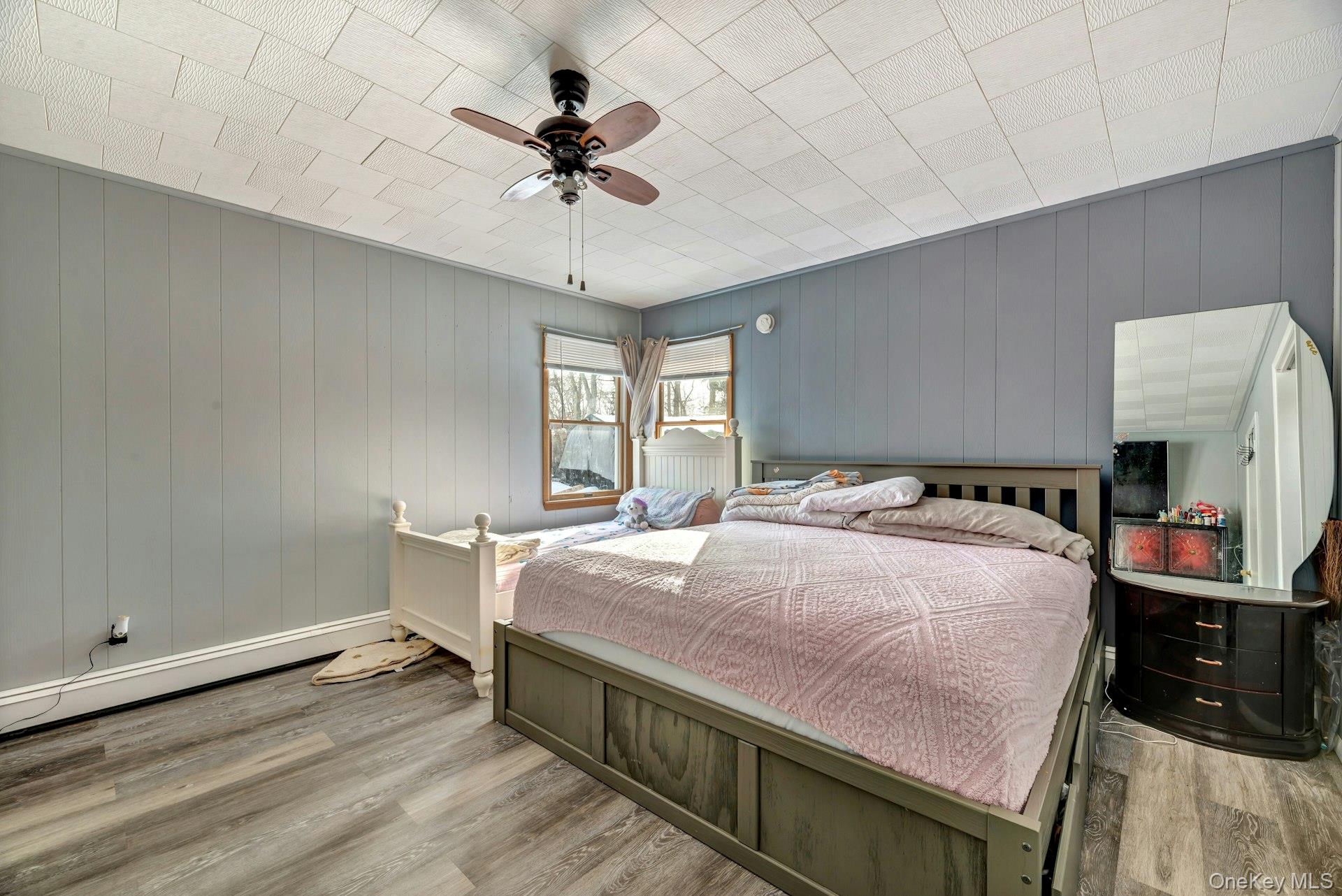 32 Stackyard Drive Mastic Beach, NY 11951 - Photo 21 of 25 a bed room with a bed and a chandelier
