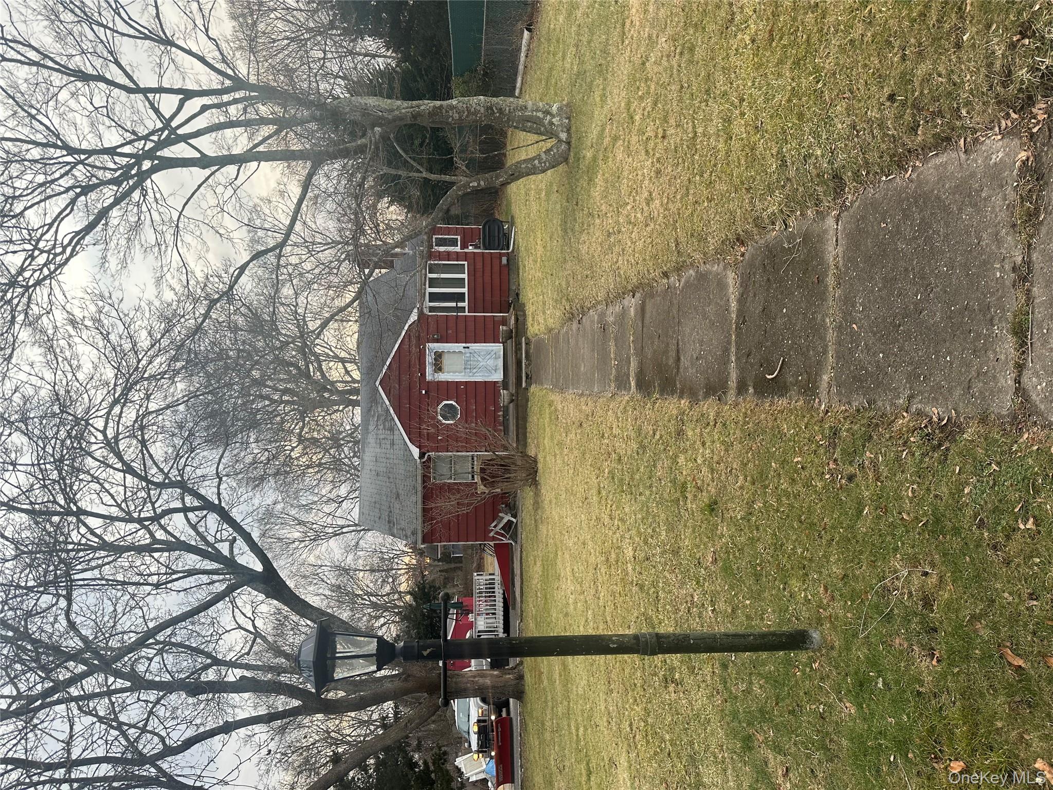 32 Stackyard Drive Mastic Beach, NY 11951 - Photo 23 of 25 a front view of a house with a yard