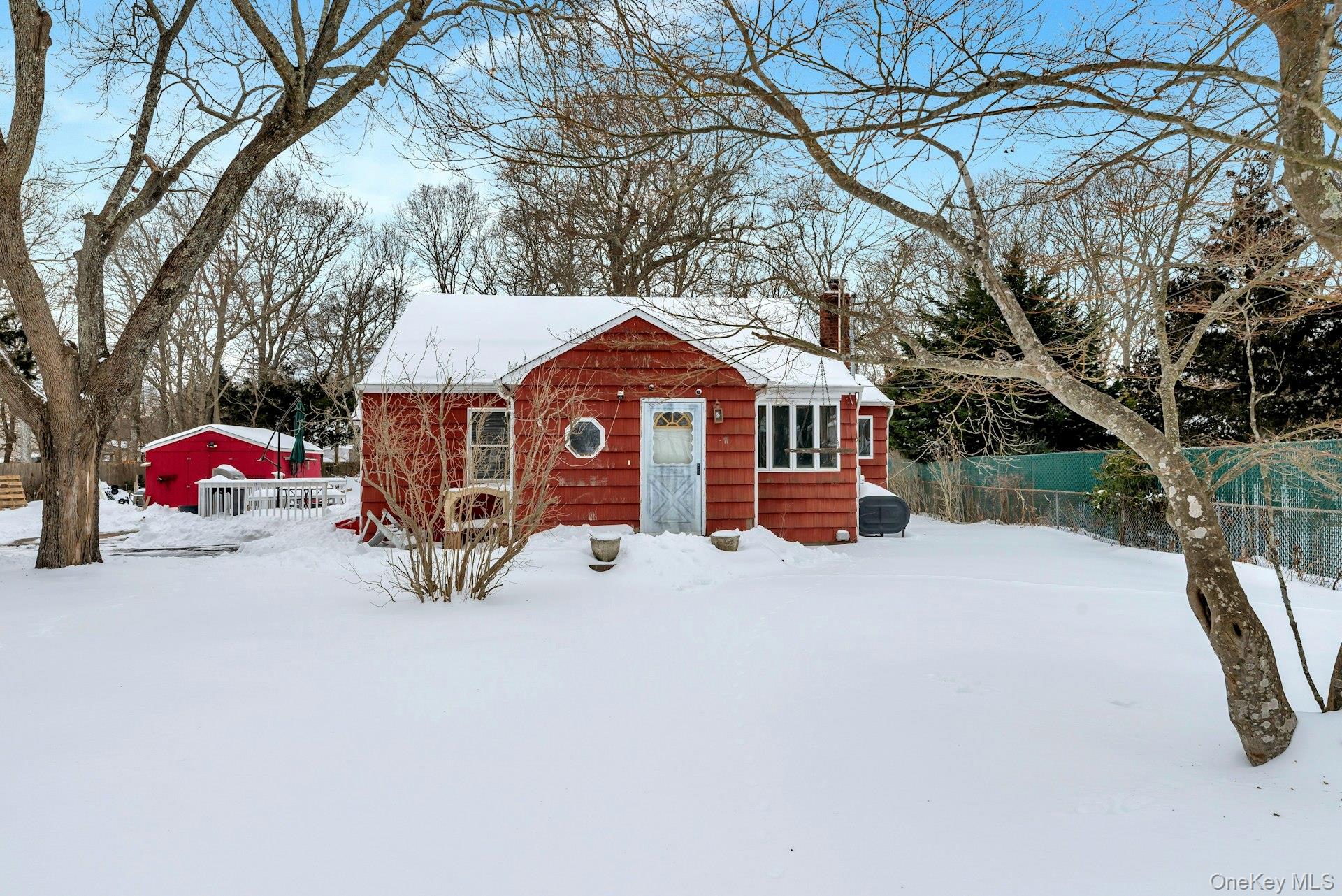 32 Stackyard Drive Mastic Beach, NY 11951 - Photo 3 of 25 a front view of a house with a yard covered with snow in front of house