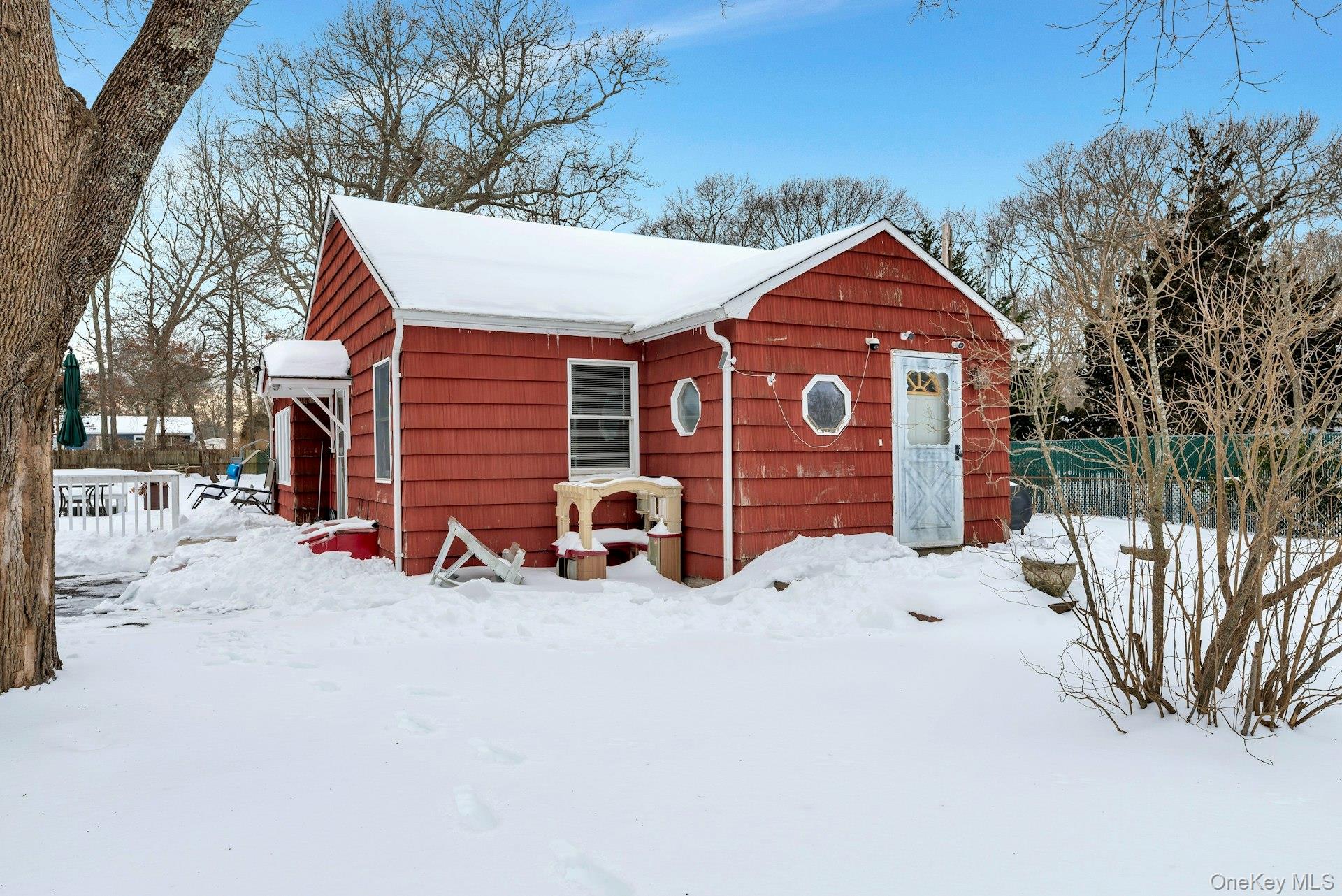 32 Stackyard Drive Mastic Beach, NY 11951 - Photo 3 of 25 a view of a house with a yard covered in snow