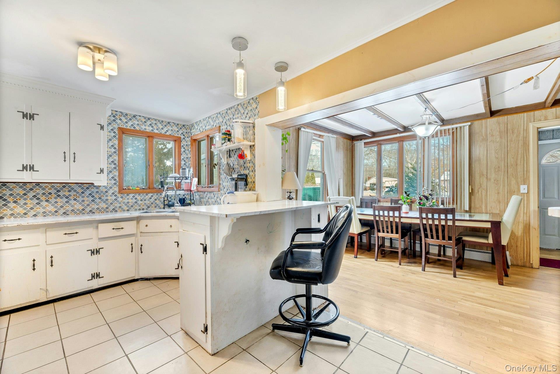 32 Stackyard Drive Mastic Beach, NY 11951 - Photo 6 of 25 a kitchen with cabinets and chairs