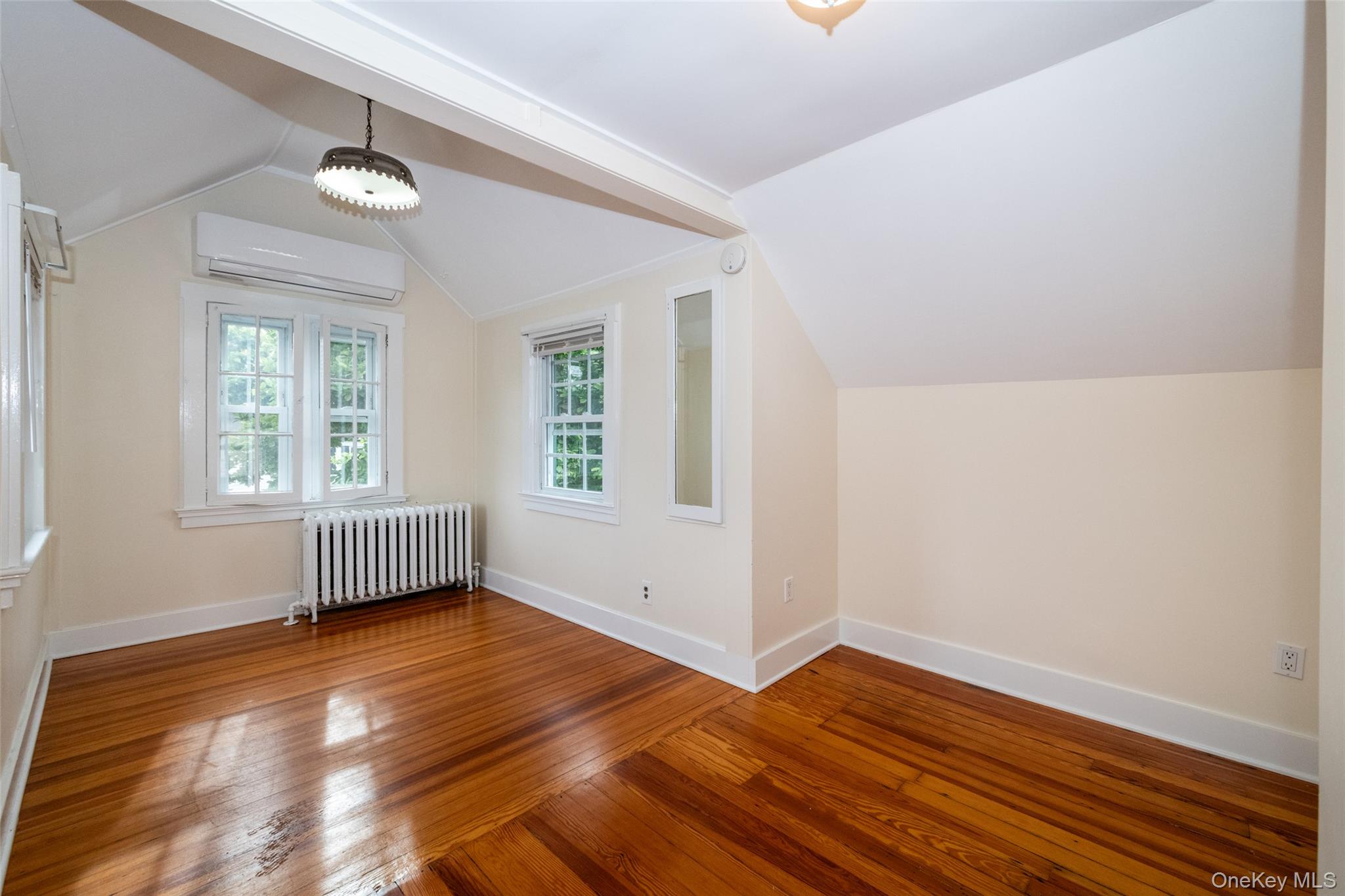 82 Clove Road New Rochelle, NY 10801 - Photo 28 of 39 an empty room with wooden floor and windows