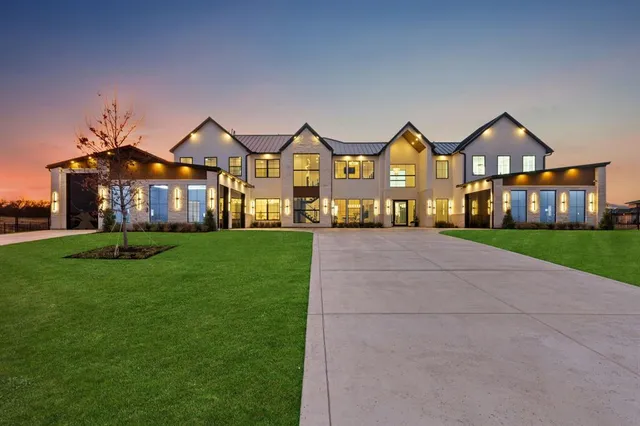 a view of a big house with a big yard and large trees