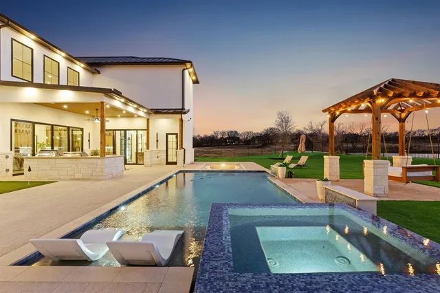 a view of a house with swimming pool and sitting area