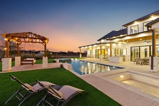 a patio with table and chairs with the garden view