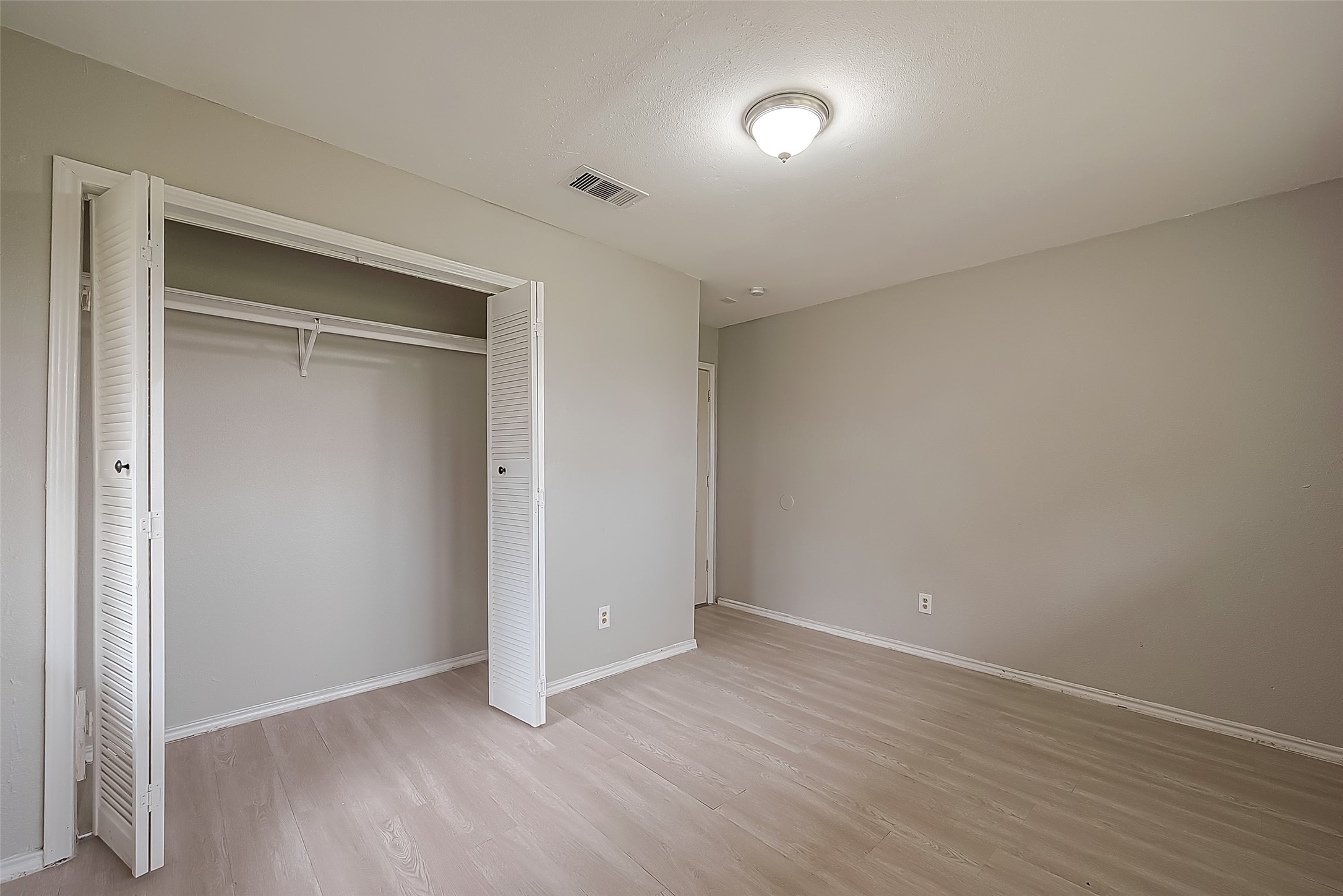 11615 Duane Street Houston, TX 77047 - Photo 11 of 14 an empty room with wooden floor and closet