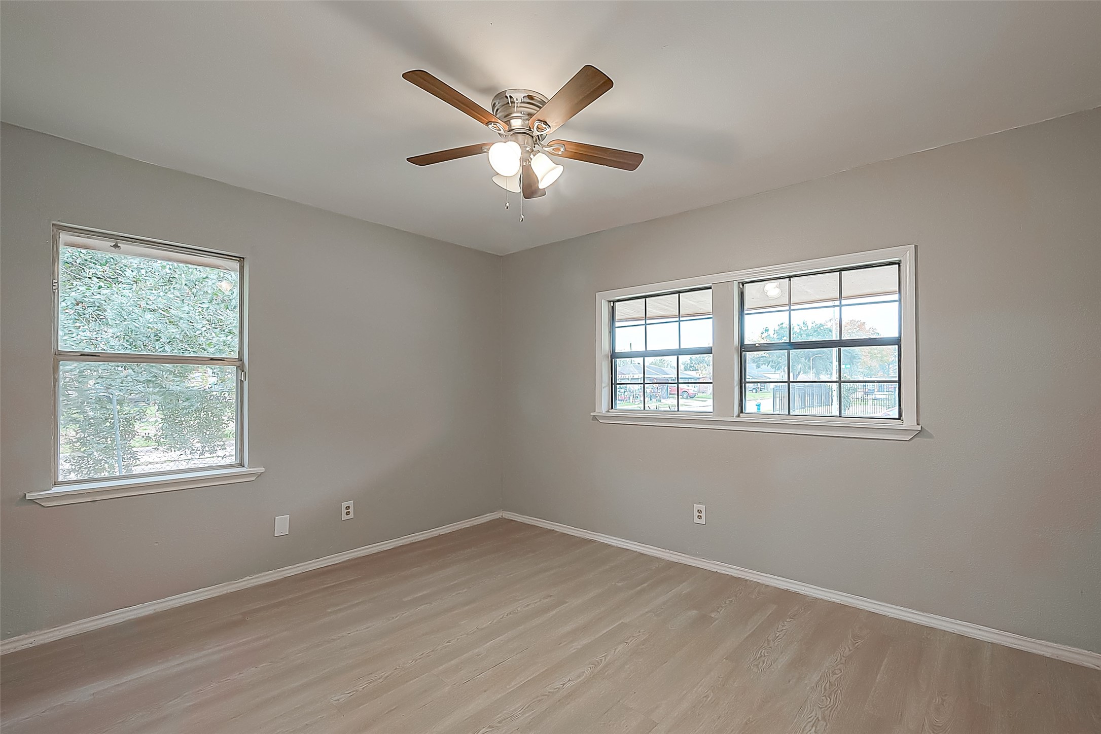 11615 Duane Street Houston, TX 77047 - Photo 4 of 14 a view of an empty room with wooden floor and a window